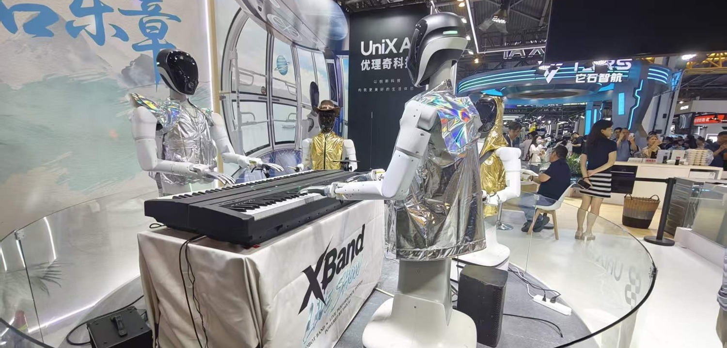 A robot performing live at an “XBand” show booth